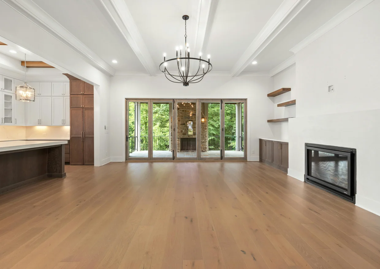 Contemporary living room featuring hardwood floors, chandelier, and open kitchen layout in Littleton