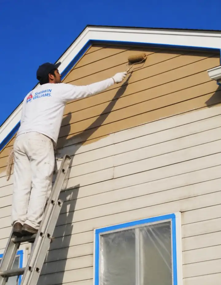Front Range Paint Pros worker painting home exterior