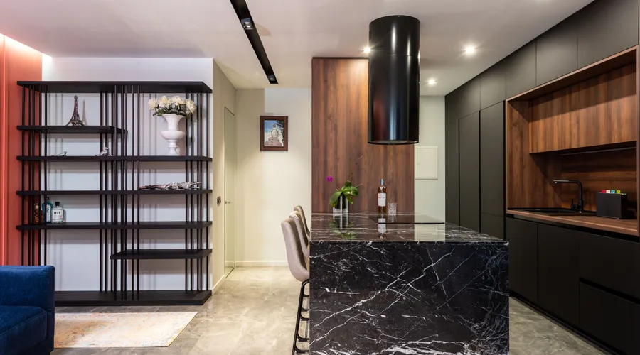 Where Black Paint Works Best in Your Home - Modern kitchen interior with black marble island and wooden cabinets