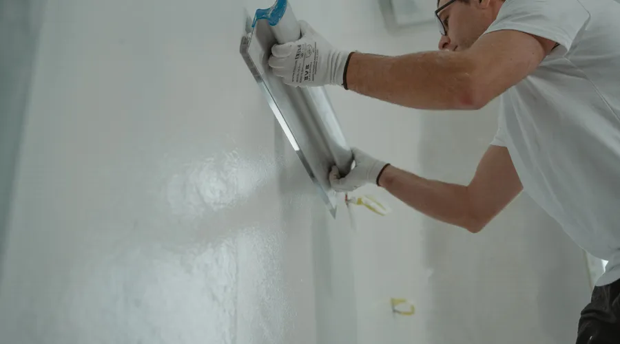 What Is Paint and Primer in One? - A man works on home renovation