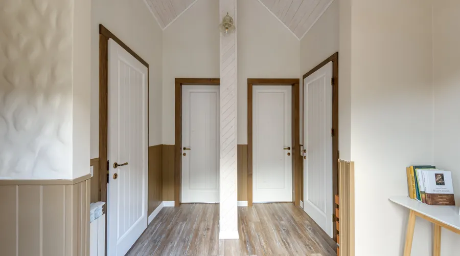 Which Should You Choose? - Bright hallway with wooden flooring and three doors