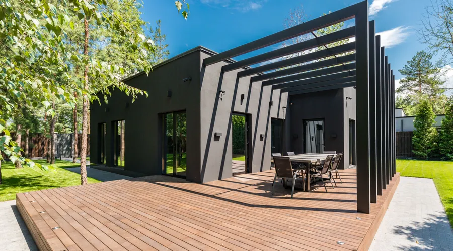 How to Paint Decking Quickly With a Roller - Stylish outdoor space with wooden deck and dining set