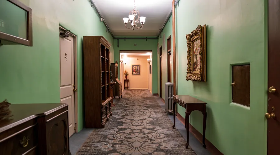 1. Benjamin Moore Scuff-X - A vintage-style hotel hallway adorned with classic furnishings and a chandelier