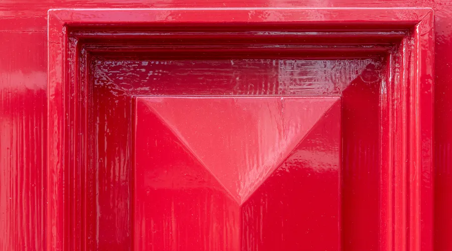 How Long Does It Take? - Close-up of a vibrant red door featuring a geometric design