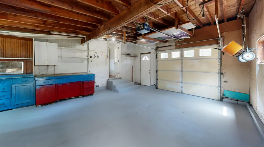 What You'll Need - Empty garage with open space and colorful storage cabinets