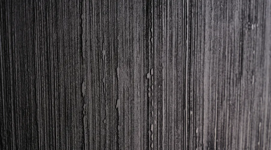 Surface Compatibility - Close-up shot of a textured black and white wall with a unique linear pattern