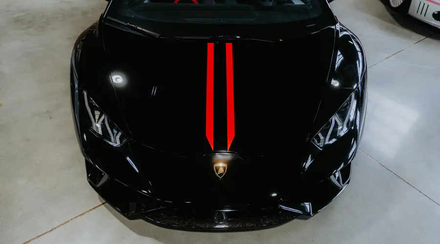 What Is Polyaspartic Garage Floor Coating? - Top view of a shiny black sports car with a distinctive red stripe