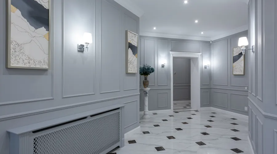 Benjamin Moore Interior Paint - Interior of corridor of contemporary villa with shiny tiled floor and gray walls decorated with paintings and lamps